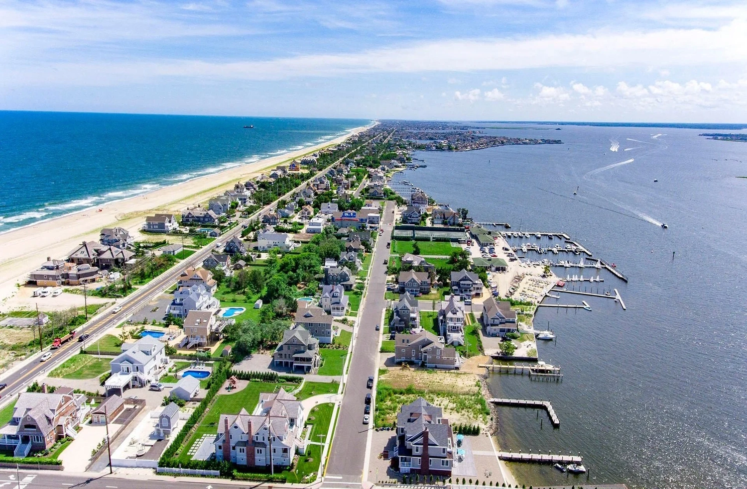 Aerial view of the Mantoloking barrier island showing homes nestled between the Atlantic Ocean and Barnegat Bay