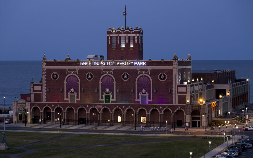 Asbury Park boardwalk and Convention Hall at twilight, highlighting the vibrant Monmouth County coastal lifestyle