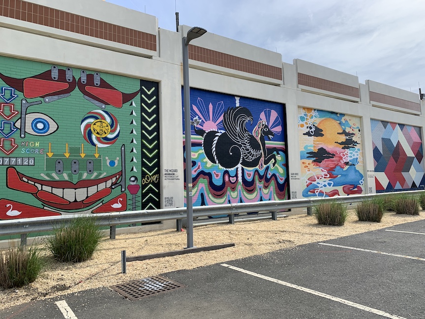 Vibrant and colorful street murals on a wall in Asbury Park, NJ, showcasing the city's bold arts culture and creative community